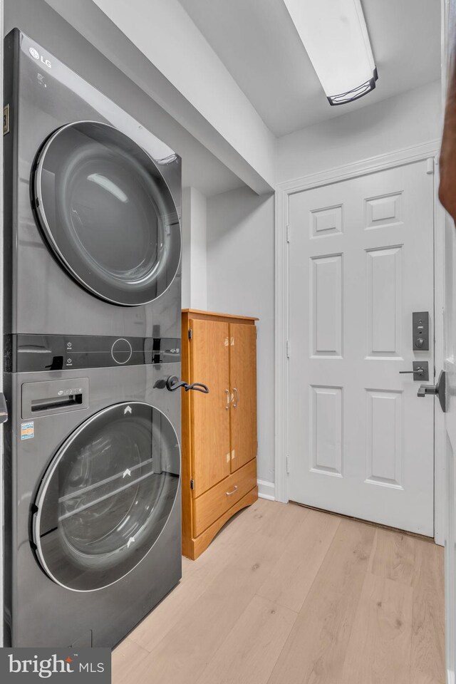 1606 Montmorency Dr, Vienna, VA 22182 - washroom with stacked washing machine and dryer and wood finished floors