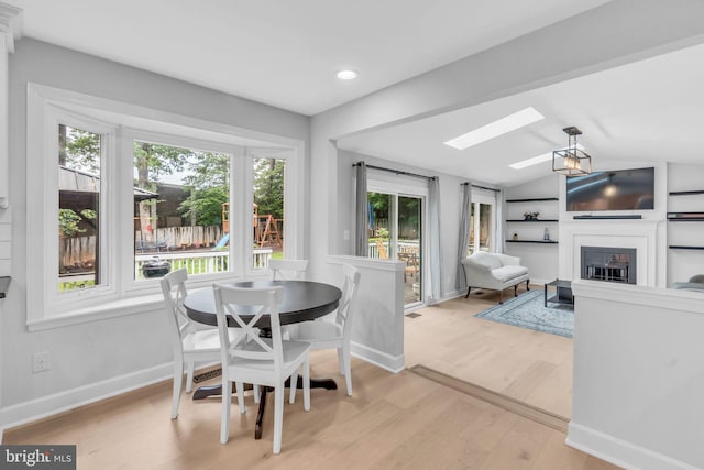 1606 Montmorency Dr, Vienna, VA 22182 - dining area featuring a skylight, light wood-style floors, a fireplace, recessed lighting, and baseboards
