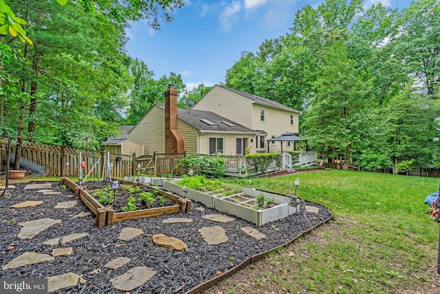 1606 Montmorency Dr, Vienna, VA 22182 - view of yard featuring a garden and a storage unit