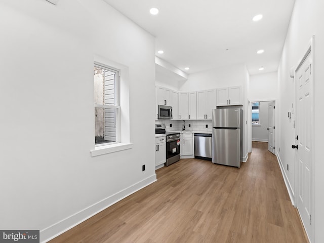 2331 N Front St, Philadelphia, PA 19133 - kitchen featuring stainless steel appliances, recessed lighting, light countertops, backsplash, and light wood-style flooring