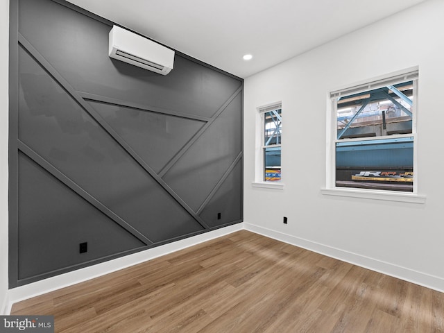 2331 N Front St, Philadelphia, PA 19133 - empty room featuring a wall unit AC, wood finished floors, baseboards, and recessed lighting