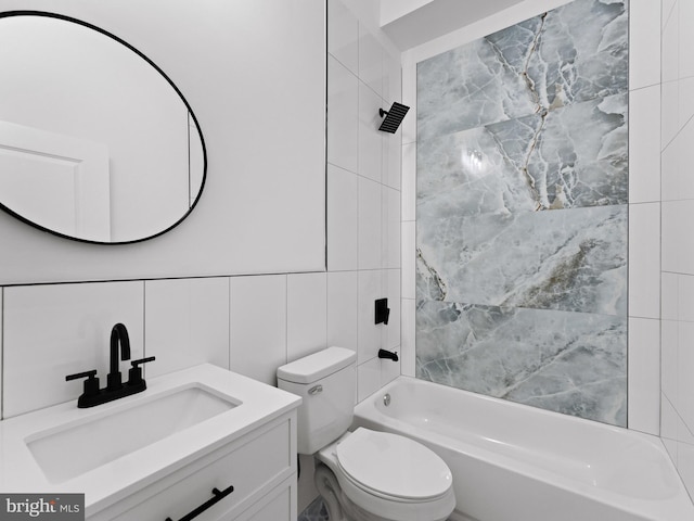 2331 N Front St, Philadelphia, PA 19133 - bathroom featuring bathing tub / shower combination, vanity, toilet, and tile walls