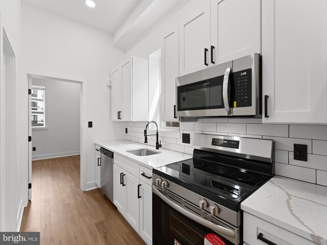 2331 N Front St, Philadelphia, PA 19133 - kitchen with appliances with stainless steel finishes, a sink, tasteful backsplash, white cabinetry, and recessed lighting