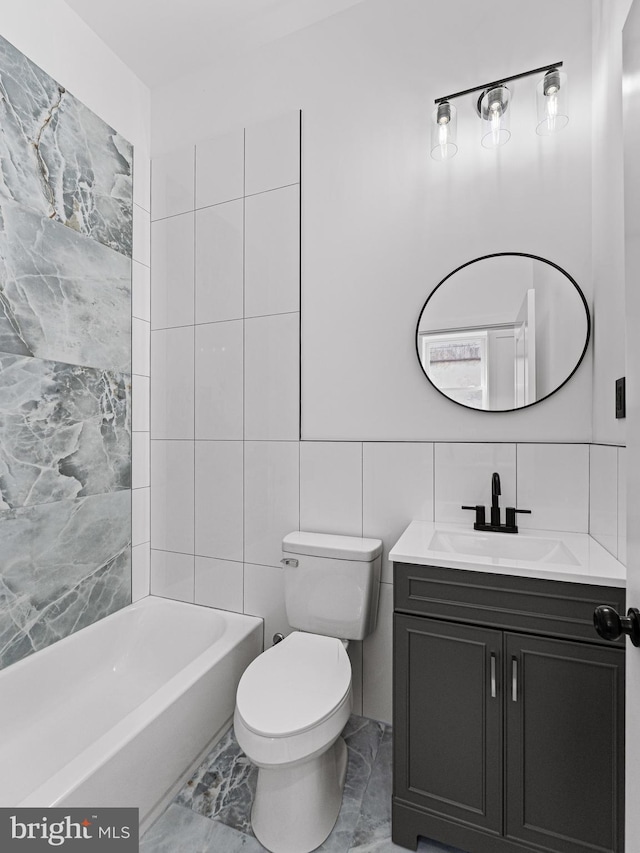 2331 N Front St, Philadelphia, PA 19133 - bathroom featuring vanity, marble look tiles, toilet, tile walls, and  shower combination