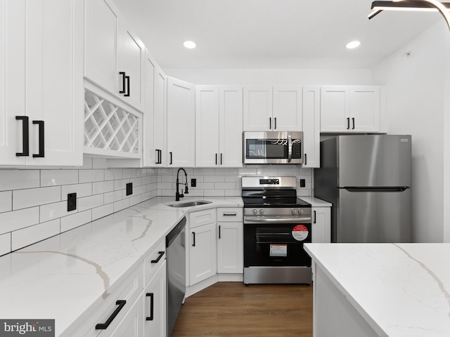 2331 N Front St, Philadelphia, PA 19133 - kitchen with stainless steel appliances, a sink, white cabinets, tasteful backsplash, and recessed lighting
