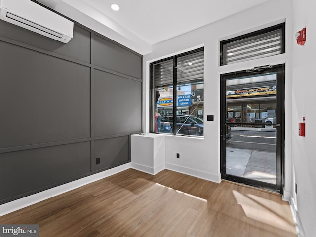 2331 N Front St, Philadelphia, PA 19133 - unfurnished room with a wall unit AC, wood finished floors, baseboards, and beverage cooler
