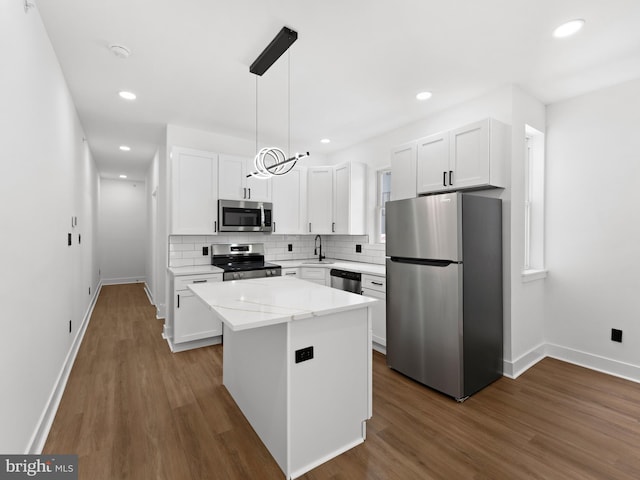 2331 N Front St, Philadelphia, PA 19133 - kitchen featuring appliances with stainless steel finishes, baseboards, a sink, tasteful backsplash, and dark wood-style flooring