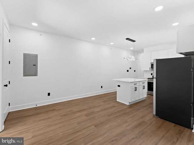 2331 N Front St, Philadelphia, PA 19133 - kitchen with stainless steel appliances, electric panel, white cabinetry, light countertops, and light wood-style floors