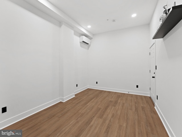 2331 N Front St, Philadelphia, PA 19133 - laundry room with a wall mounted air conditioner, wood finished floors, recessed lighting, and baseboards