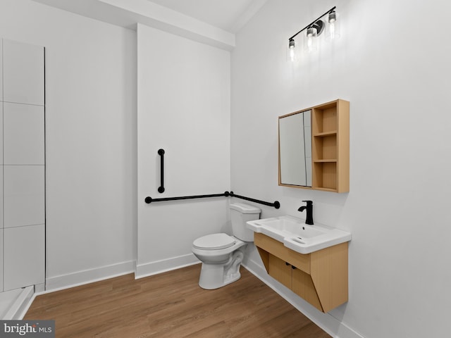 2331 N Front St, Philadelphia, PA 19133 - bathroom with baseboards, wood finished floors, vanity, and toilet