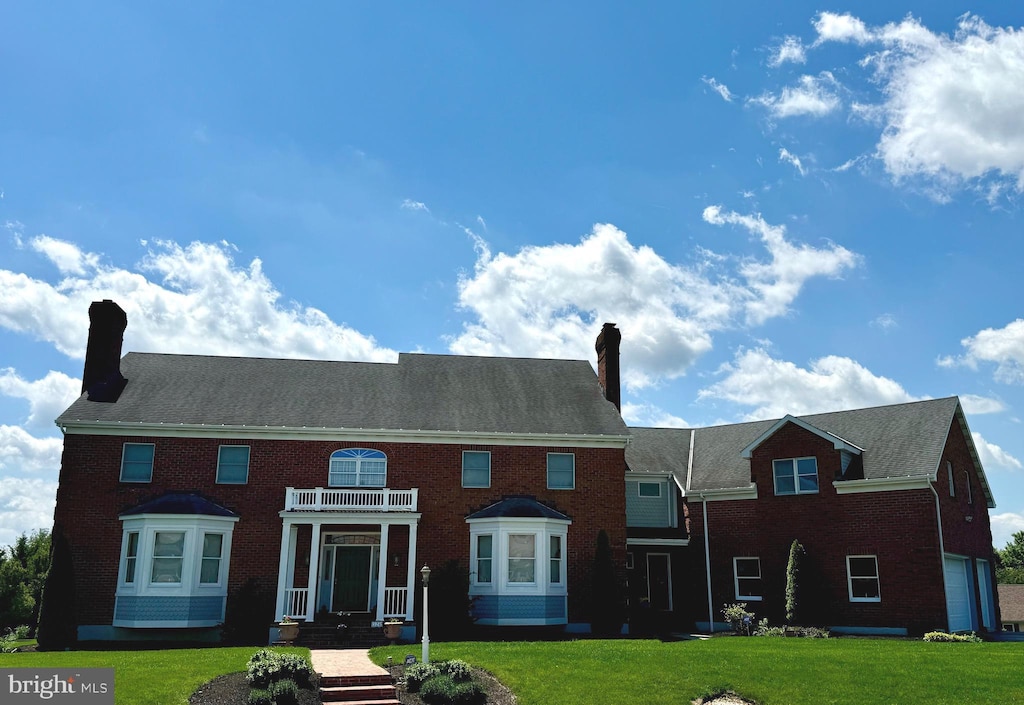 324 W Orchard Dr, Palmyra, PA 17078 - back of house with a chimney, a lawn, and brick siding