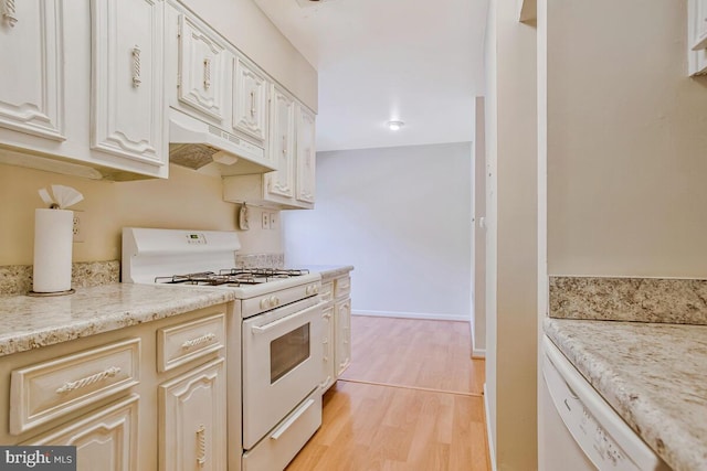 9 Silverwood Cir Unit 6, Annapolis, MD 21403 - kitchen featuring white appliances, under cabinet range hood, light wood finished floors, light stone countertops, and baseboards