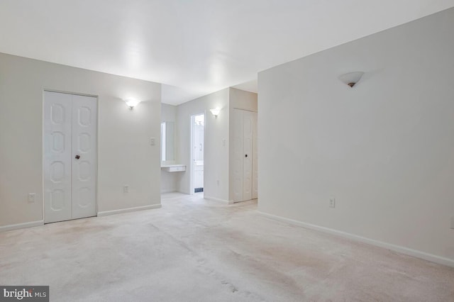 9 Silverwood Cir Unit 6, Annapolis, MD 21403 - unfurnished bedroom with baseboards, light colored carpet, connected bathroom, and two closets