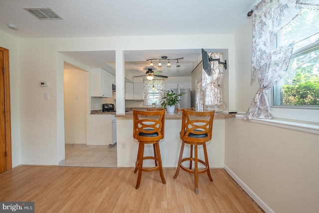 405 Garden Ln, Aston, PA 19014 - kitchen featuring white cabinets, light wood-style flooring, and plenty of natural light