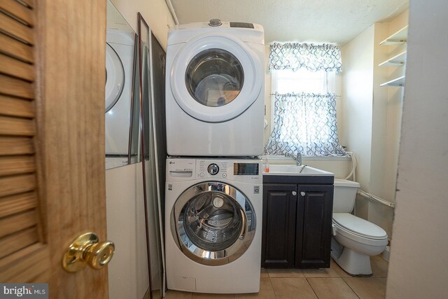 405 Garden Ln, Aston, PA 19014 - laundry room featuring stacked washing machine and dryer and light tile patterned flooring
