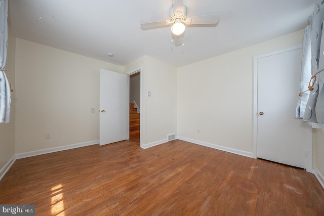 405 Garden Ln, Aston, PA 19014 - unfurnished bedroom with wood finished floors, baseboards, and a ceiling fan