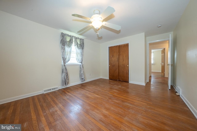 405 Garden Ln, Aston, PA 19014 - unfurnished bedroom with wood finished floors, a closet, baseboards, and a ceiling fan