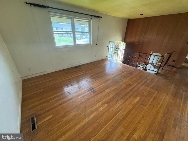 8541 Lucerne Rd, Randallstown, MD 21133 - empty room with wood finished floors, wood walls, and baseboards
