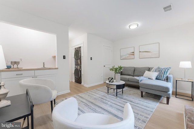 4377 Cherry Hill Rd, Arlington, VA 22207 - living area featuring stacked washer / drying machine and light wood-style floors