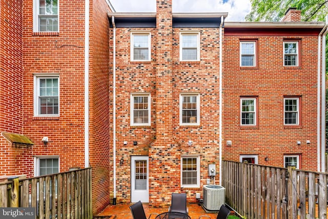 4377 Cherry Hill Rd, Arlington, VA 22207 - back of property with brick siding, a chimney, and a patio