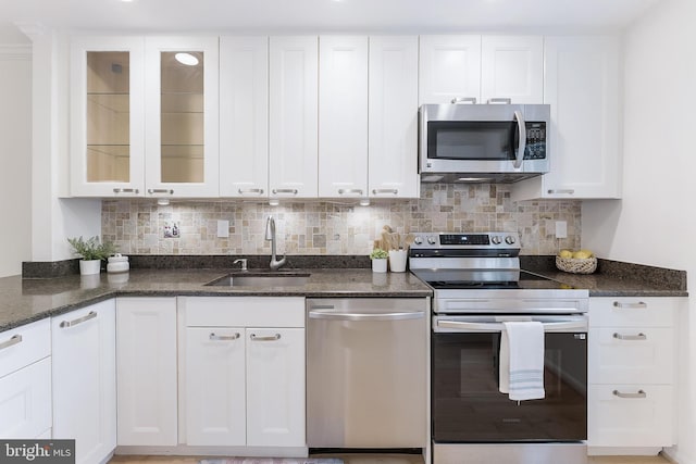 4377 Cherry Hill Rd, Arlington, VA 22207 - kitchen with stainless steel appliances, white cabinets, dark stone counters, tasteful backsplash, and glass insert cabinets