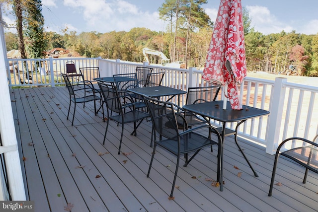 9216 Crandall Rd, Lanham, MD 20706 - wooden deck with outdoor dining space and a forest view