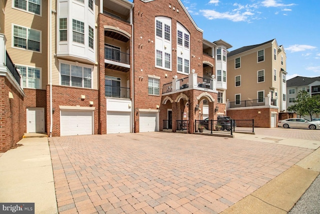 8612 Wintergreen Ct Unit 403, Odenton, MD 21113 - view of building exterior featuring an attached garage and driveway