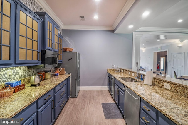 8612 Wintergreen Ct Unit 403, Odenton, MD 21113 - kitchen with stainless steel appliances, a sink, ornamental molding, baseboards, and light stone countertops