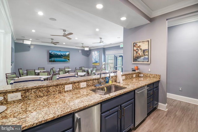 8612 Wintergreen Ct Unit 403, Odenton, MD 21113 - kitchen with a sink, crown molding, stainless steel dishwasher, light wood finished floors, and light stone counters