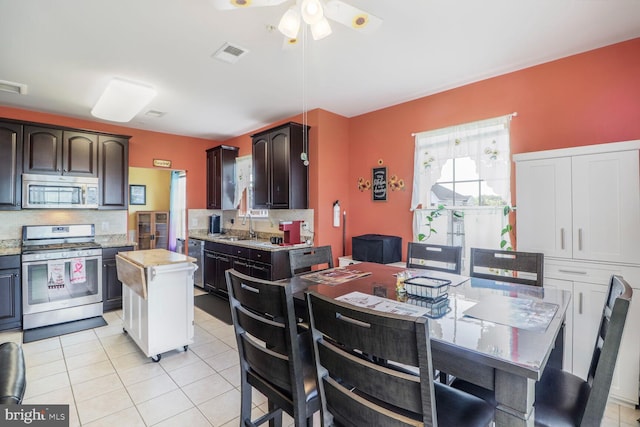 8612 Wintergreen Ct Unit 403, Odenton, MD 21113 - kitchen featuring stainless steel appliances, light countertops, a sink, a ceiling fan, and a center island