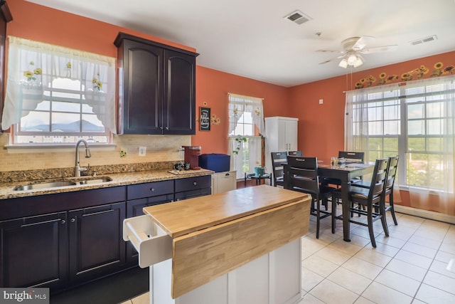 8612 Wintergreen Ct Unit 403, Odenton, MD 21113 - kitchen featuring a sink, wooden counters, ceiling fan, light tile patterned floors, and tasteful backsplash