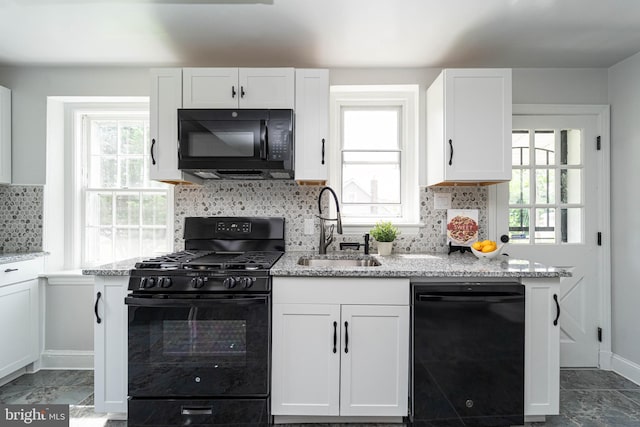 3232 N Rolling Rd, Baltimore, MD 21244 - kitchen featuring black appliances, light stone counters, white cabinets, and healthy amount of natural light