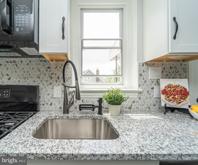 3232 N Rolling Rd, Baltimore, MD 21244 - kitchen featuring black appliances, white cabinetry, backsplash, and light stone countertops