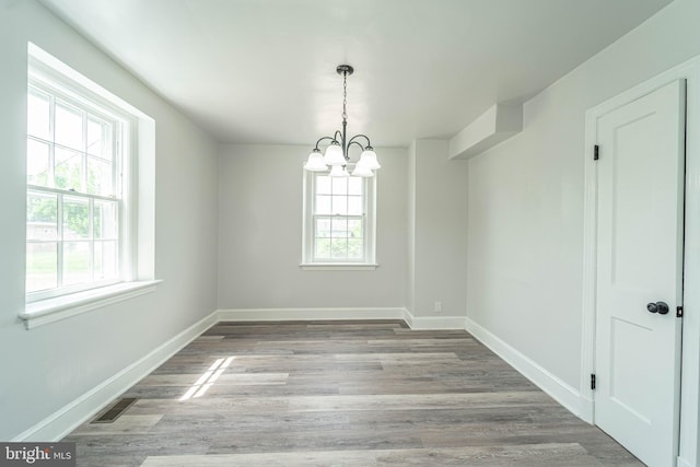 3232 N Rolling Rd, Baltimore, MD 21244 - unfurnished dining area featuring a chandelier and wood finished floors