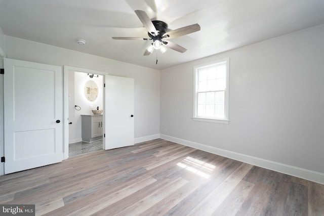 3232 N Rolling Rd, Baltimore, MD 21244 - unfurnished bedroom with light wood-style floors, ensuite bath, and ceiling fan
