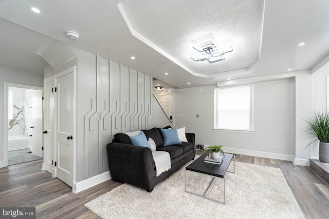 3232 N Rolling Rd, Baltimore, MD 21244 - living room featuring wood finished floors, a tray ceiling, a textured ceiling, stairway, and recessed lighting