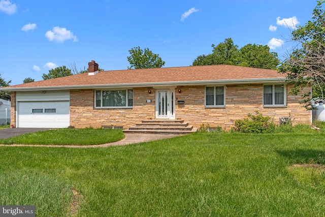 645 Lily Rd, Warminster, PA 18974 - single story home with stone siding, an attached garage, a chimney, a front lawn, and asphalt driveway