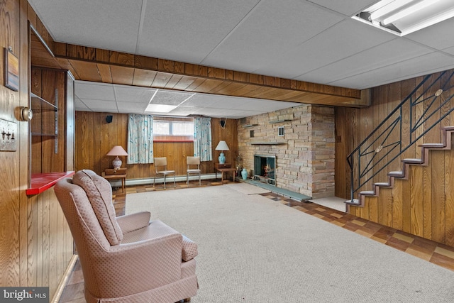 645 Lily Rd, Warminster, PA 18974 - living room with wooden walls, stairs, a fireplace, baseboard heating, and tile patterned floors