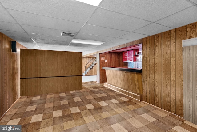 645 Lily Rd, Warminster, PA 18974 - indoor dry bar featuring wooden walls, a drop ceiling, tile patterned floors, and stairway