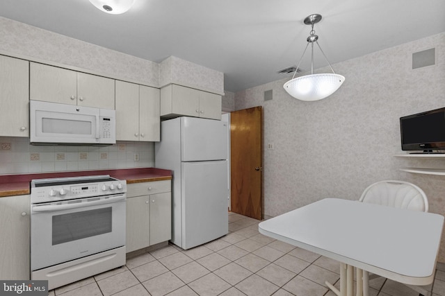 645 Lily Rd, Warminster, PA 18974 - kitchen with white appliances, light tile patterned floors, dark countertops, decorative light fixtures, and tasteful backsplash
