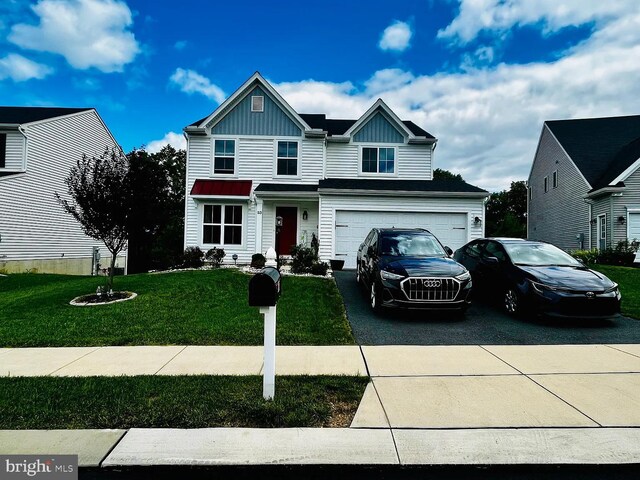 53 Shelduck Ln, Mechanicsburg, PA 17050 - traditional-style house featuring asphalt driveway, board and batten siding, a front yard, and an attached garage