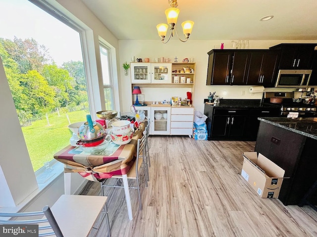 53 Shelduck Ln, Mechanicsburg, PA 17050 - kitchen featuring stainless steel microwave, a chandelier, light wood-style flooring, gas range oven, and pendant lighting