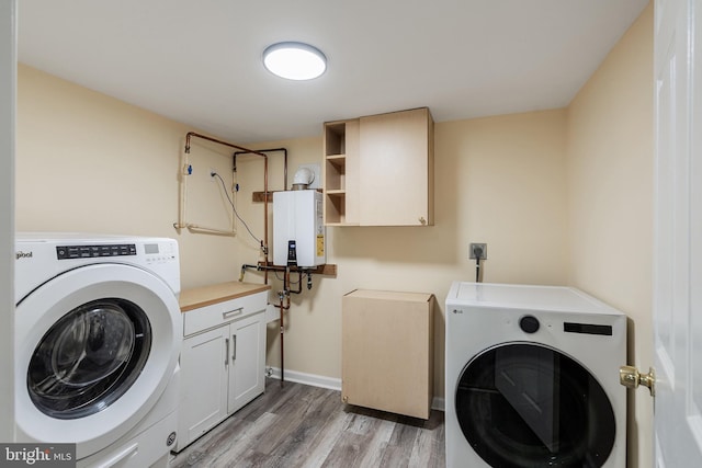 136 Pemberton Browns Mill Rd, Browns Mills, NJ 08015 - laundry room with water heater, separate washer and dryer, light wood finished floors, and cabinet space