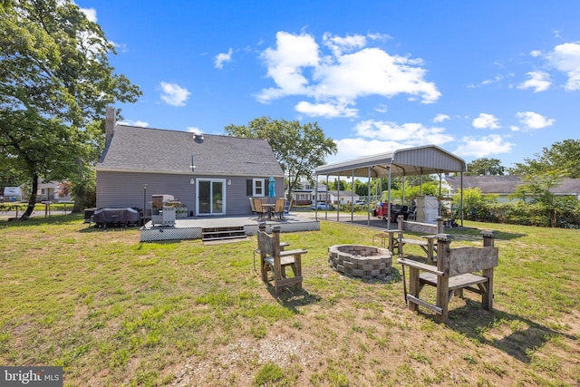 17 S Jefferson Ave, National Park, NJ 08063 - back of property with an outdoor fire pit, a carport, a wooden deck, and a lawn