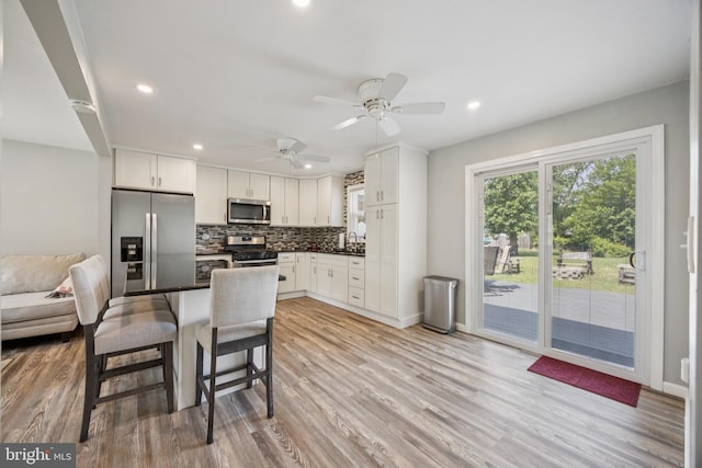 17 S Jefferson Ave, National Park, NJ 08063 - kitchen with stainless steel appliances, a sink, backsplash, white cabinets, and recessed lighting
