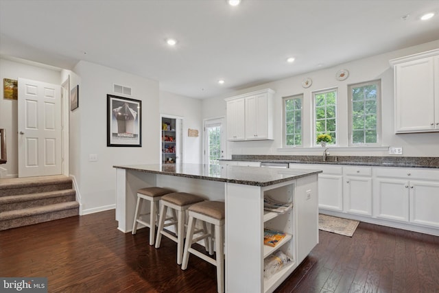 468 Rowan St, Warminster, PA 18974 - kitchen with a center island, white cabinetry, dark wood finished floors, dark stone counters, and a kitchen breakfast bar