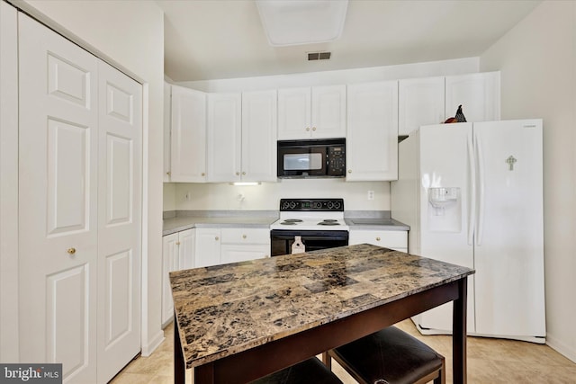 7 Brook Farm Ct Unit 7E, Perry Hall, MD 21128 - kitchen with black microwave, white refrigerator with ice dispenser, electric range oven, a kitchen breakfast bar, and white cabinets
