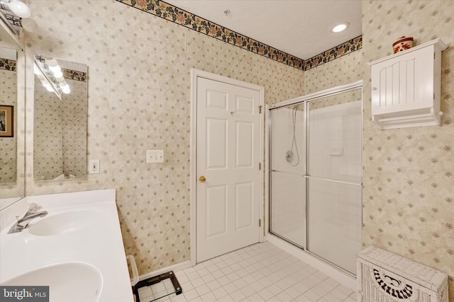 7 Brook Farm Ct Unit 7E, Perry Hall, MD 21128 - bathroom featuring wallpapered walls, tile patterned flooring, a stall shower, double vanity, and baseboards