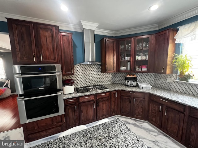 6810 Ashleys Crossing Ct, Temple Hills, MD 20748 - kitchen featuring appliances with stainless steel finishes, wall chimney range hood, healthy amount of natural light, decorative backsplash, and crown molding