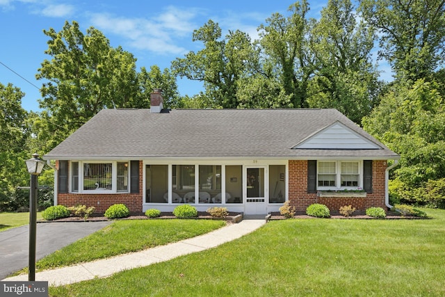 39 Stoney Run Rd, Wilmington, DE 19809 - view of front of property featuring brick siding, a front lawn, a chimney, and roof with shingles